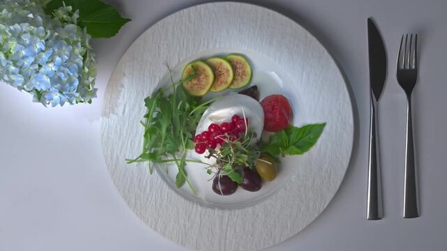 Exquisite gourmet salad plate with figs and cheese top view video background