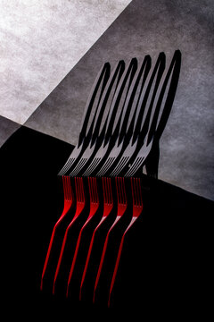 Still life with red and black forks