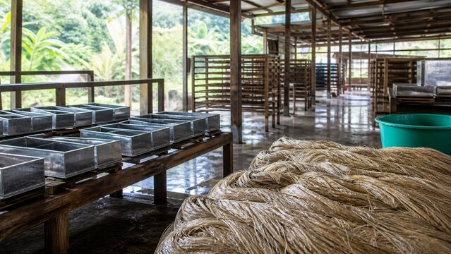 Coarse natural fiber material piled high in a rustic setting, texture study for crafting and design, embodies earthy tones and raw materials, ideal for bohemian or artisanal projects