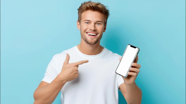 Smiling young man presenting blank white smartphone screen on blue background offering or website promotion app