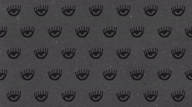 Seamless animated pattern of stylized evil eye symbols on dark grey background.