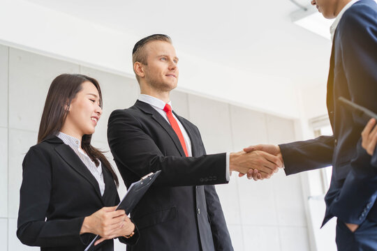 Group of business people handshake in meeting.