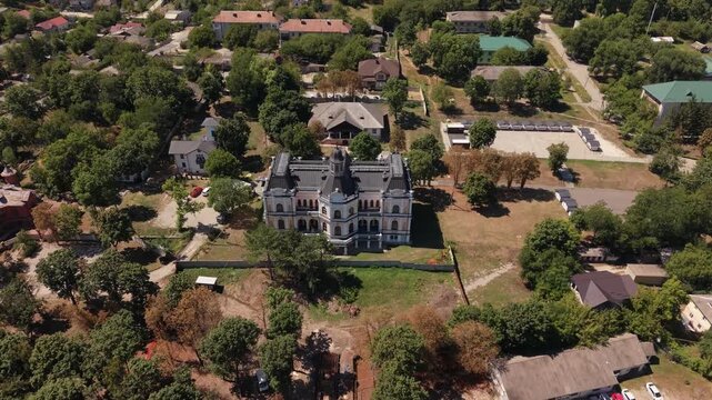 Aerial drone view of Manuc Bey Mansion, also known as Manuc Bei Manor, a historic architectural landmark in Hincesti, Moldova. The footage shows the restored palace and surrounding estate, gardens