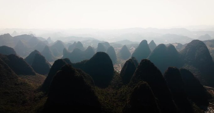 Layers of dramatic karst peaks fade into atmospheric haze in Yangshuo.