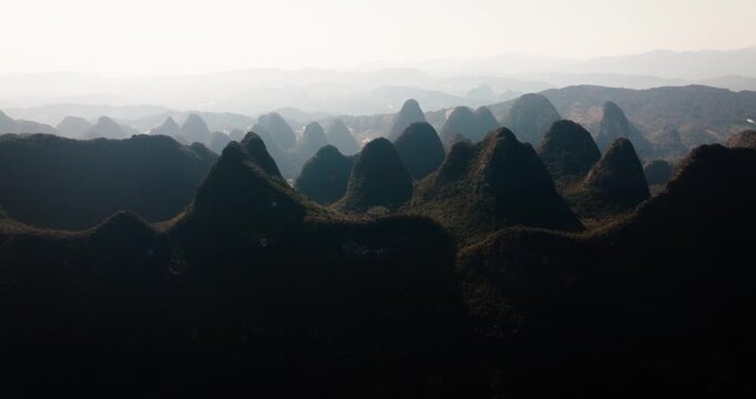 Layers of karst mountains fade into soft atmospheric haze in Yangshuo.