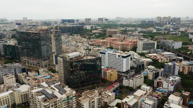 under construction glass facade buildings with Corporate office and Residential apartments at Hitec city, madhapur, hyderabad, telangana, india. day time, push back shot, drone shot, 4k.