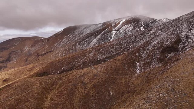 A majestic 4K 30fps aerial view of the Tongariro Alpine Crossing on the North Island. This smooth drone clip captures the epic, otherworldly terrain of the iconic Middle Earth cinematic landscape
