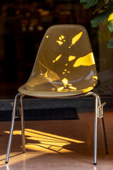 Fototapeta premium Modern Transparent Chairs in Warm Sunlight