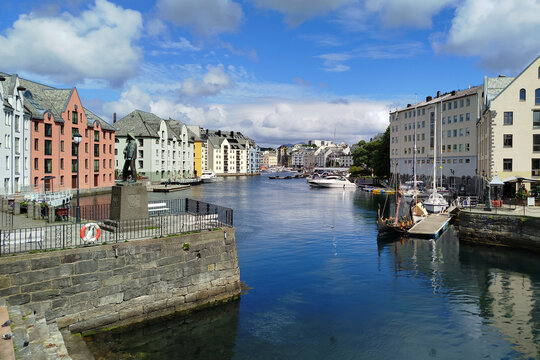 Beautiful waterfront Art Nouveau architecture and docked boats along Brosundet canal in Alesund, Norway. 