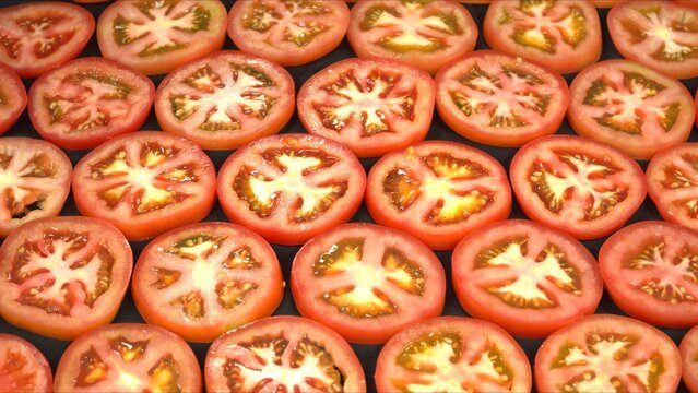 Fresh red tomatoes whole, cut half with knife on wooden board, and sliced texture pattern.