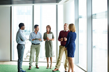 Obraz premium Window, meeting and business people in office for real estate, property management and discussion. Lobby, team and workers talking for commercial development, housing expansion and auction listing