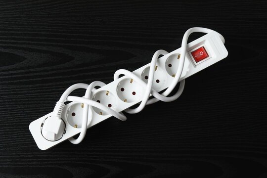 Electric extension cord on a colored background
