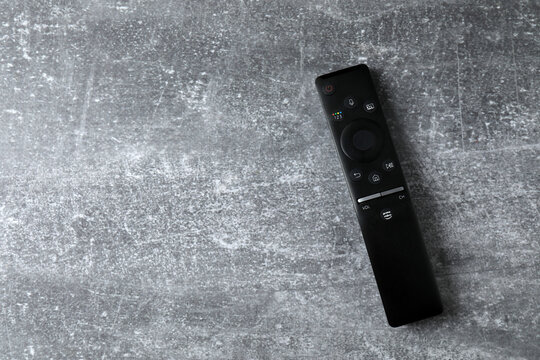 TV remote control on a color background.
