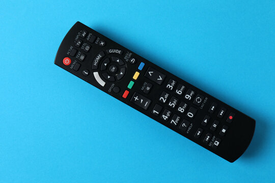 TV remote control on a color background.
