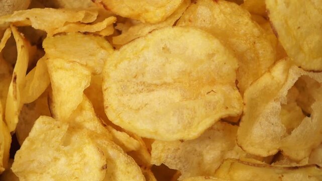 Rotation of salted potato chips as a texture. Top view	