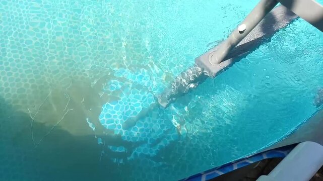 Swimming pool vacuum filter removes dirt and sediment from the bottom as water circulates, showing pool cleaning and maintenance in a bright horizontal close-up.