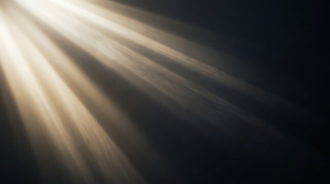 Dramatic golden sunburst light rays on transparent black background for overlays and effects