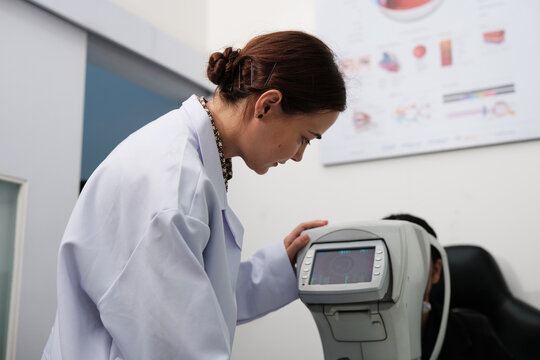 Female patient eye exam with refractometer device, vision and eyesight improvement by expert optometrist woman, diagnostic for eyeglasses lens, professional technology services in optical clinic.