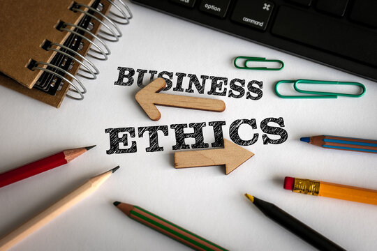 BUSINESS ETHICS Concept with Direction Arrows and Office Supplies