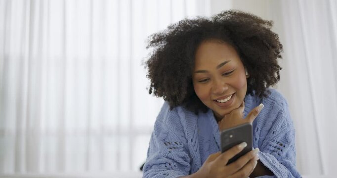 Black African woman with attractive smile use tablet smartphone on white bed, Portrait beauty girl relax in bedroom. Technology people connection digital online marketing e-commerce concept banner