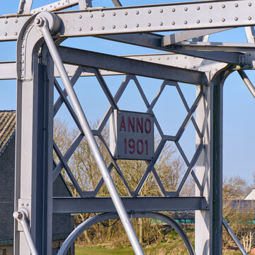 Historical engineering and water management in Friesland Nederland close-up of a metal bridge structure with 'Anno 1901' inscription near Ezumazijl