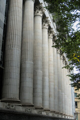 Fluted stone columns and carved capitals of a colonnade seen from below © Ekaterina