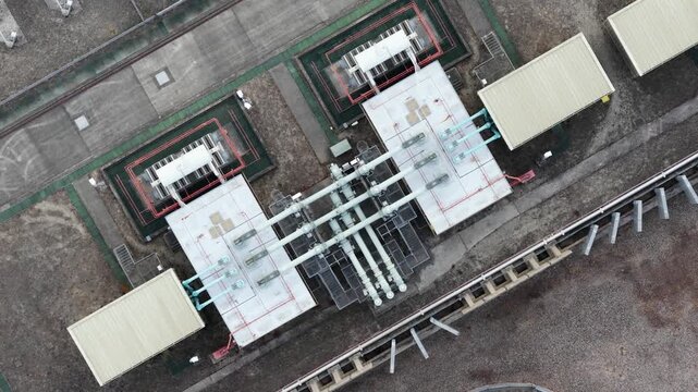 Aerial top down view of a high voltage electrical power substation with transformers and distribution equipment, an essential component of the modern energy grid and power generation industry
