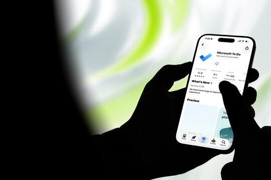 Kiel, Germany - 08-20-2026: Smartphone displaying the Microsoft To Do task management and productivity app in the App Store, held by silhouetted hands with blurred background