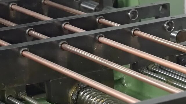 Witness the intricate process of manufacturing copper tubes designed for industrial air conditioners. This close-up look reveals the machinery in action, working with precision and care.