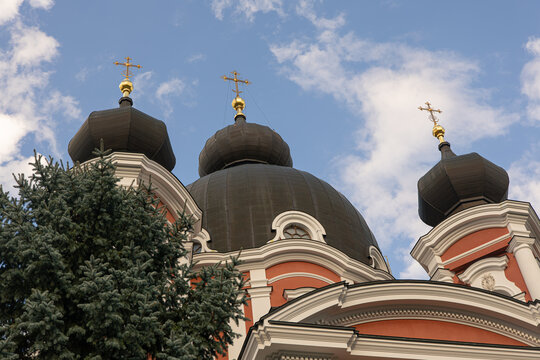 Roof of large historical church with crosses against open sky, religious architecture and faith concept