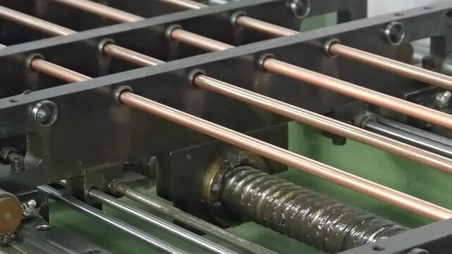 Discover the intricate process of shaping copper tubing as advanced machinery orchestrates metal with precision. Watch as each part works together beautifully in a rhythmic dance of engineering.