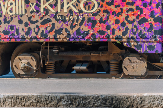 Colorful patterned tram wheel assembly with visible branding from Kiko Milano and Roberto Cavalli in Milan, Italy