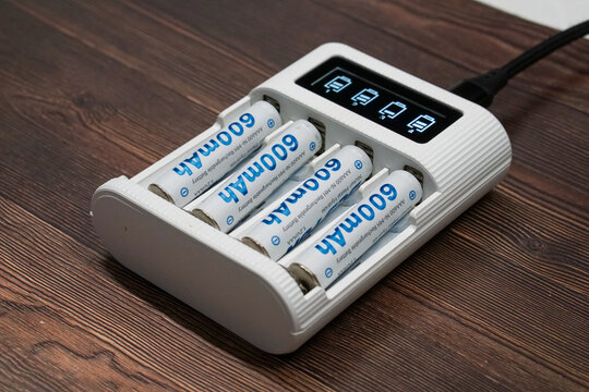 Smart Battery Charger with AAA Ni-MH Batteries on Wood