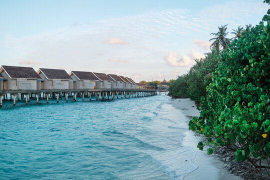 Water villas over turquoise ocean water