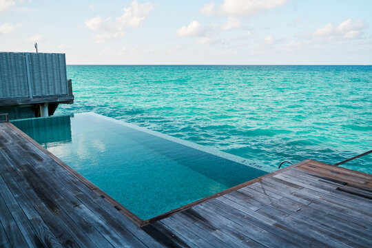 An infinity pool overlooks the turquoise ocean