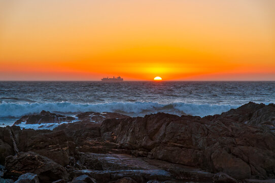 Bloubergstrand Sunset Over Atlantic Ocean With Cargo Ship