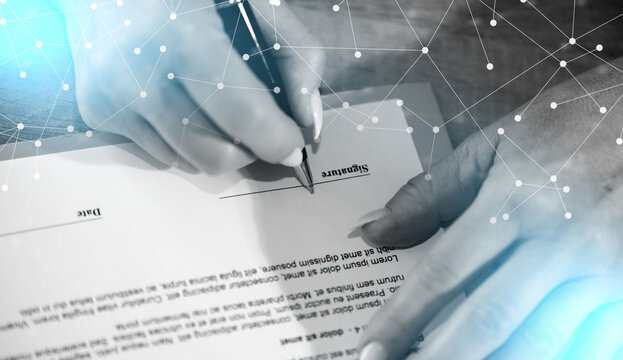 Hand of businesswoman signing a document; light effect