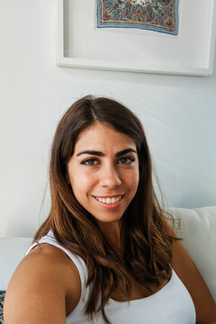 A young white woman smiling inside a modern icelandic home