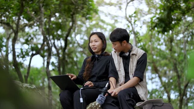 Sound Recordists Capturing Natural Forest Ambience with Microphone and Laptop