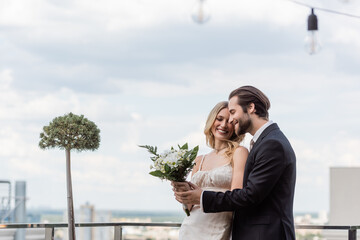 Fototapeta premium Blonde woman and bearded man share a joyful moment with an engagement ring