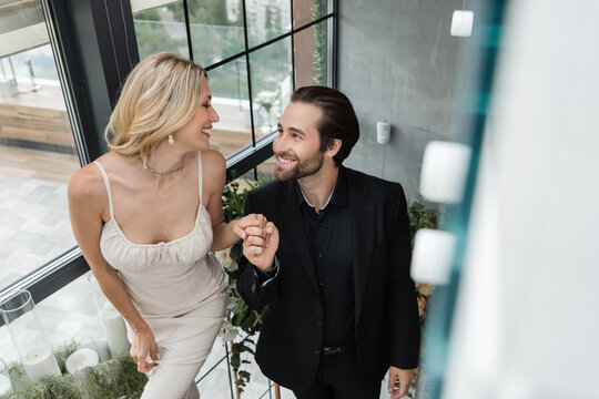A delighted couple shares a joyful moment, planning their future together above the city