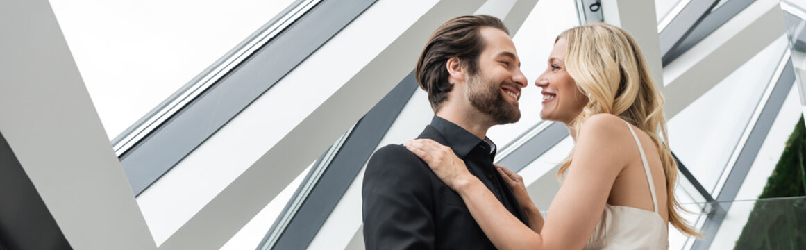 Blonde woman and bearded man celebrate their love and engagement with smiles, banner 
