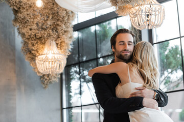 Fototapeta premium A romantic couple embraces joyfully after an unforgettable marriage proposal