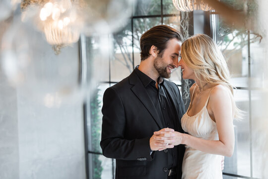 A beautiful couple embraces as they celebrate their engagement 
