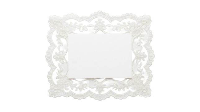 Blank white rectangular card framed by intricate floral lace border on solid white background