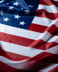 Fototapeta premium Patriotic waving american flag with stars and stripes closeup