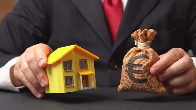 A residential building and a euro money bag. Buying a house, investing in real estate. Housing market trends. Home renovation loan.