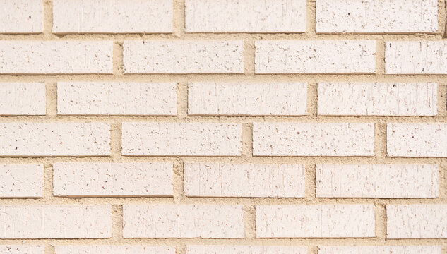 Wall texture background. Brick wall structure. Industrial brick stone wall. Brick masonry background. Building material concept. Surface of white brickwall. Textured beige brick backdrop