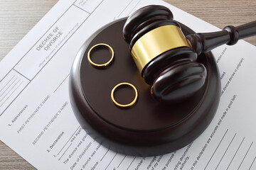 Divorce Decree with Gavel and Wedding Rings
