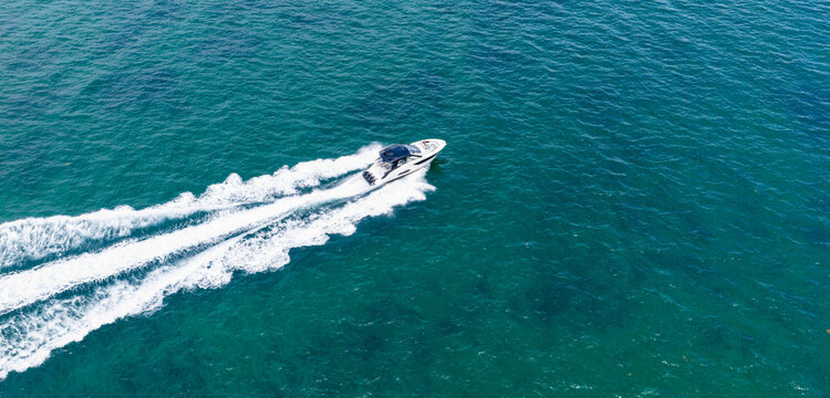 Yacht boat tour. Luxury boat yachting. Motorboat sailing at sea. Luxury private yacht in sea. Motor yacht luxurious vessel. Boat motor aerial. Vacation on summer. Aerial view motorboat